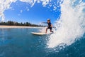 Young surfer learn to ride on surfboard on sea waves Royalty Free Stock Photo