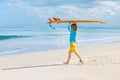 Young surfer learn to ride on surfboard on sea waves