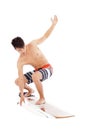 Young surfer make a surfing pose Royalty Free Stock Photo