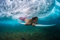 Young surfer make trick named Duck Dive Royalty Free Stock Photo