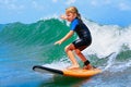 Young surfer rides on surfboard with fun on sea waves Royalty Free Stock Photo