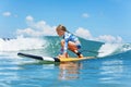 Young surfer rides on surfboard with fun on sea waves Royalty Free Stock Photo