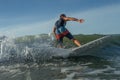 Young surfer with rides wave Royalty Free Stock Photo