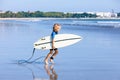 Young surfer run to ride on surfboard on sea waves Royalty Free Stock Photo