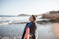 Young surfer with surfboard on the beach Royalty Free Stock Photo