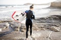 Young surfer with surfboard on the beach Royalty Free Stock Photo
