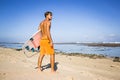young surfer with surfing board standing on sandy beach Royalty Free Stock Photo
