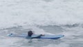 A young surfer is swamped by an incoming wave at Lighthouse point, Santa Cruz