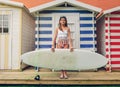 Young surfer woman with top and bikini holding Royalty Free Stock Photo