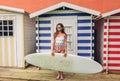 Young surfer woman with top and bikini holding surfboard Royalty Free Stock Photo