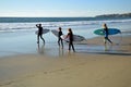 Young surfers head for the surf at Oak Street Beach in Laguna Beach, California. Royalty Free Stock Photo