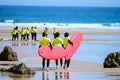 Young surfers train on Playa de Palombina Las Camaras in Celorio, Green coast of Asturias, North Spain with sandy beaches, cliffs