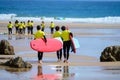 Young surfers train on Playa de Palombina Las Camaras in Celorio, Green coast of Asturias, North Spain with sandy beaches, cliffs