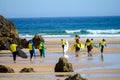 Young surfers train on Playa de Palombina Las Camaras in Celorio, Green coast of Asturias, North Spain with sandy beaches, cliffs