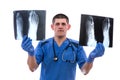 Young surgeon examining an x-ray image foot of the patient isolated on white background