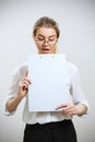 Young surprised business woman looking on folder. Royalty Free Stock Photo
