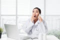 Young surprised female doctor sitting at office desk and working Royalty Free Stock Photo