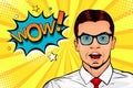 Young surprised man in glasses with open mouth and Wow speech bubble. Pop art illustration