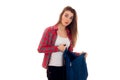 Young surprised student girl with backpack posing isolated on white background in studio Royalty Free Stock Photo