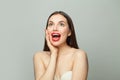 Young surprised woman brunette with clear skin on white background Royalty Free Stock Photo