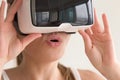 Young amazed woman wearing VR headset cant believe her eyes