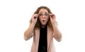 Young surprised woman holding her glasses with hands. Isolated white background