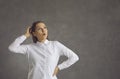 Young surprised woman scratching head looking up standing over studio background Royalty Free Stock Photo