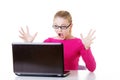 Young surprised woman sitting in front of laptop. Royalty Free Stock Photo