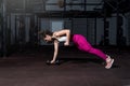 Young sweaty fit muscular strong girl doing hardcore cross workout training for back muscles with heavy dumbbell weight on the flo Royalty Free Stock Photo