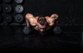 Young sweaty strong fit muscular man with big muscles doing push ups on the dumbbells in the gym hardcore cross workout training Royalty Free Stock Photo