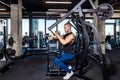 Young sweaty strong muscular fit bodybuilder man back muscles workout training with weights on the machine in the gym Royalty Free Stock Photo