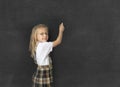 Young sweet junior schoolgirl with blonde hair smiling happy writing with chalk in blackboard