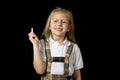 Young sweet junior schoolgirl with blonde hair standing happy and smiling holding chalk