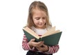 Young sweet little 6 or 7 years old with blond hair girl reading Royalty Free Stock Photo