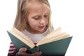 Young sweet little 6 or 7 years old with blond hair girl reading a book looking curious and fascinated Royalty Free Stock Photo