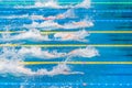 Young swimmers in outdoor swimming pool during competition. Health and fitness lifestyle concept with kids. Royalty Free Stock Photo