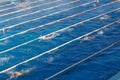 Young swimmers in outdoor swimming pool during freestyle race. Health and fitness lifestyle. Royalty Free Stock Photo