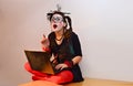 Beautiful young girl mime, got a great idea near laptop. Royalty Free Stock Photo