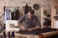 Young tailor marking fabric with chalk in atelier Royalty Free Stock Photo