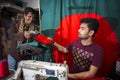 A young tailor Md. Rashed Alam , Age 28 making Bangladeshi national flags at Dhaka, Bangladesh. Royalty Free Stock Photo