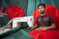 A young tailor Md. Rashed Alam , Age 28 making Bangladeshi national flags at Dhaka, Bangladesh. Royalty Free Stock Photo