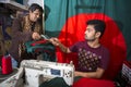 A young tailor Md. Rashed Alam , Age 28 making Bangladeshi national flags at Dhaka, Bangladesh. Royalty Free Stock Photo