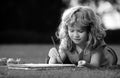 Young talented boy artist painter. Portrait of smiling happy kid enjoying art and craft drawing in backyard or spring Royalty Free Stock Photo