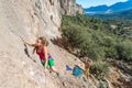 Young talented Female Rock Climber ascending rocky Wall Royalty Free Stock Photo