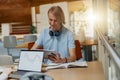 Young talented male student studying on digital tablet sit in university library Royalty Free Stock Photo