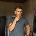 Young talented man with a brush in a gray T-shirt