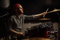 Young talented man emotionally play the drums