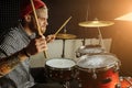 Young talented man emotionally play the drums