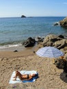 Young tanned woman in swimming suit sunbathing on a sandy beach Royalty Free Stock Photo