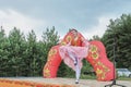 Young Tatar girl in folklore clothes performing traditional dance on stage while rural holiday